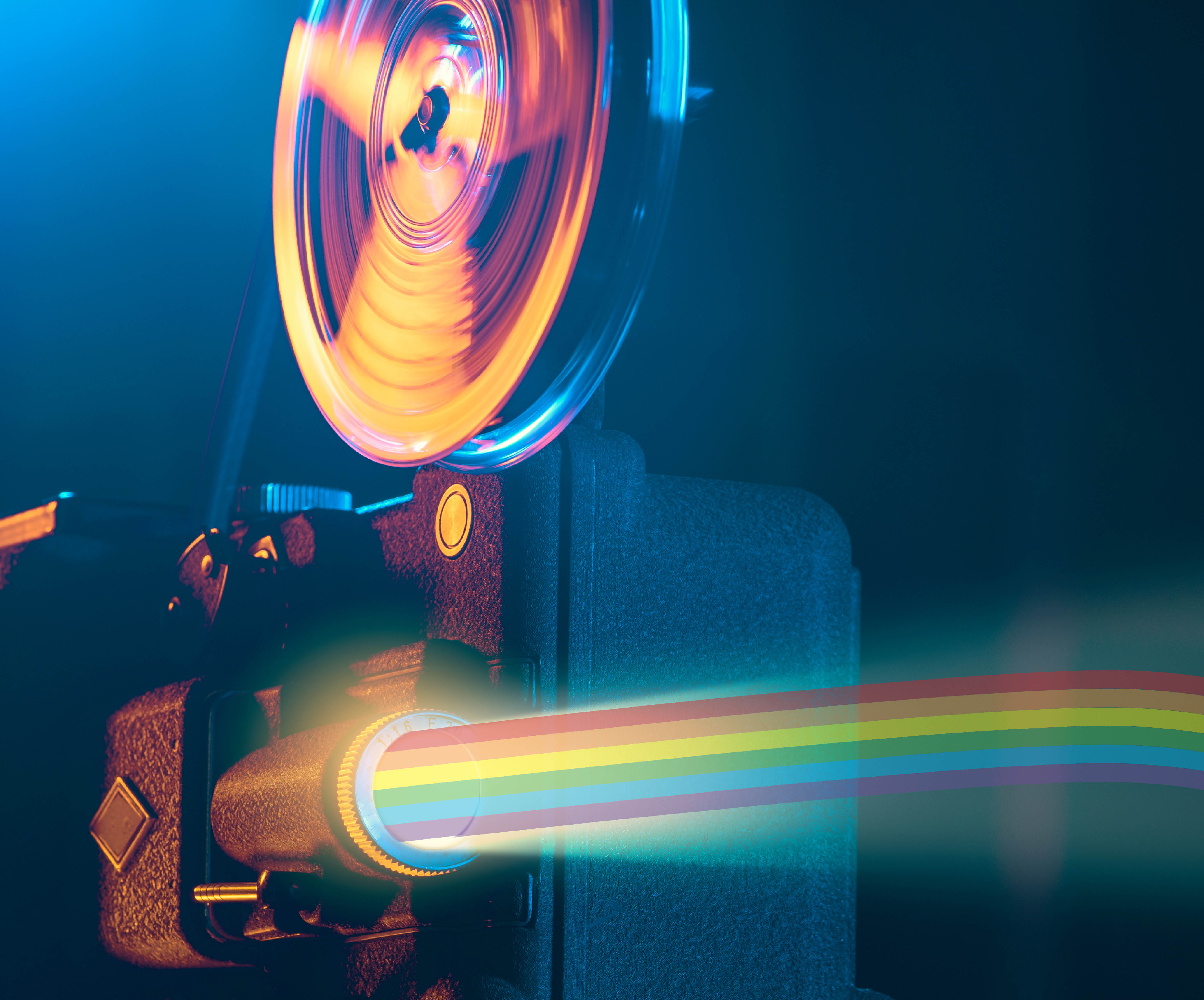 Old fashioned projector with a pride rainbow projecting from lens