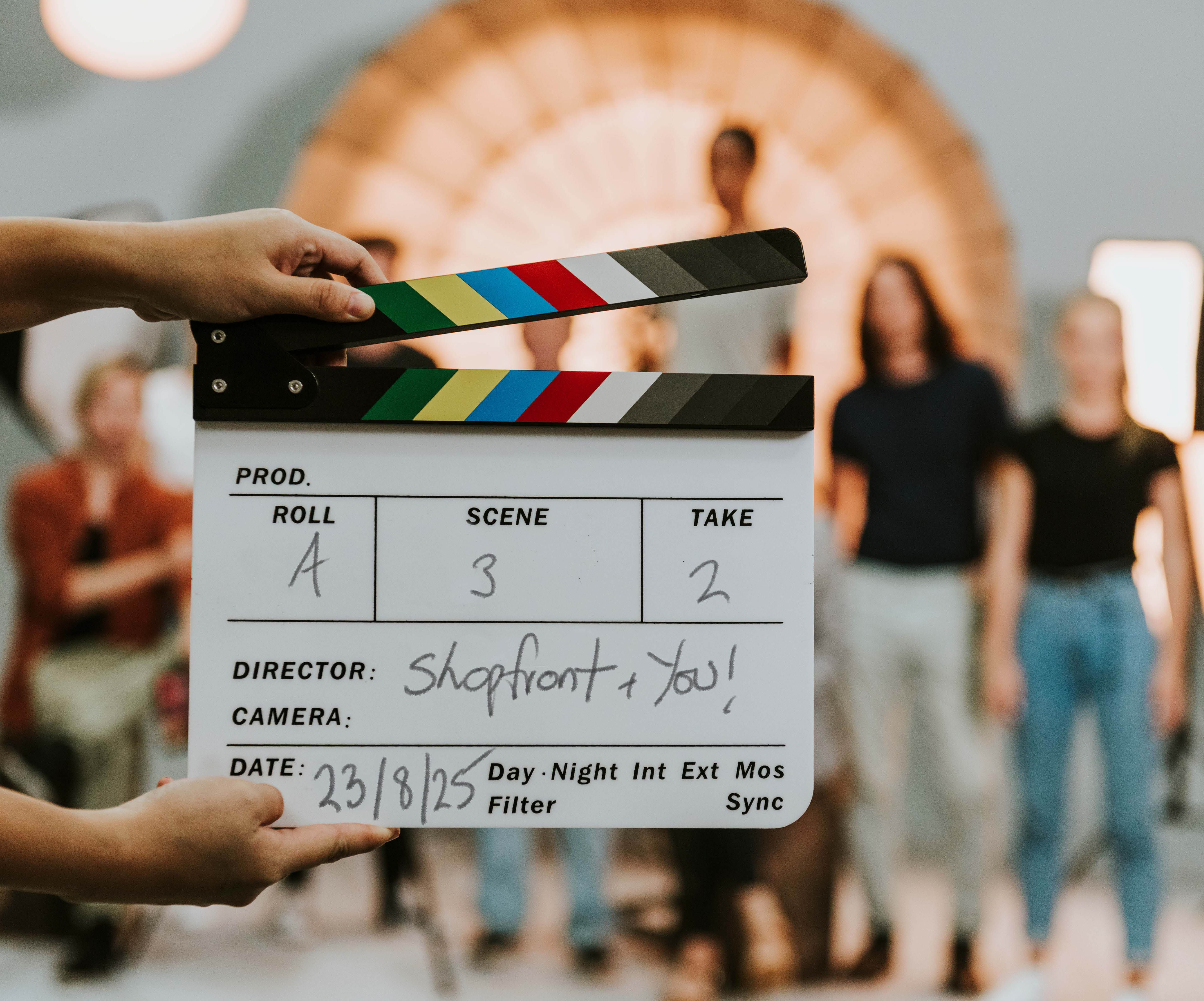 actors on sound stage behind clap board