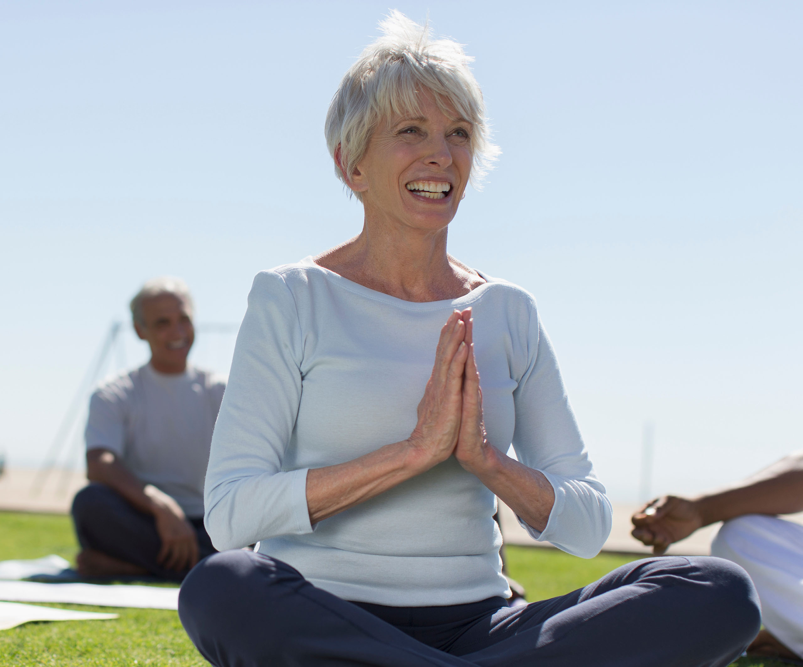 senior woman practicing yoga outside