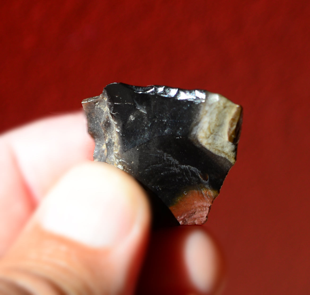 A small stone tool held in close up