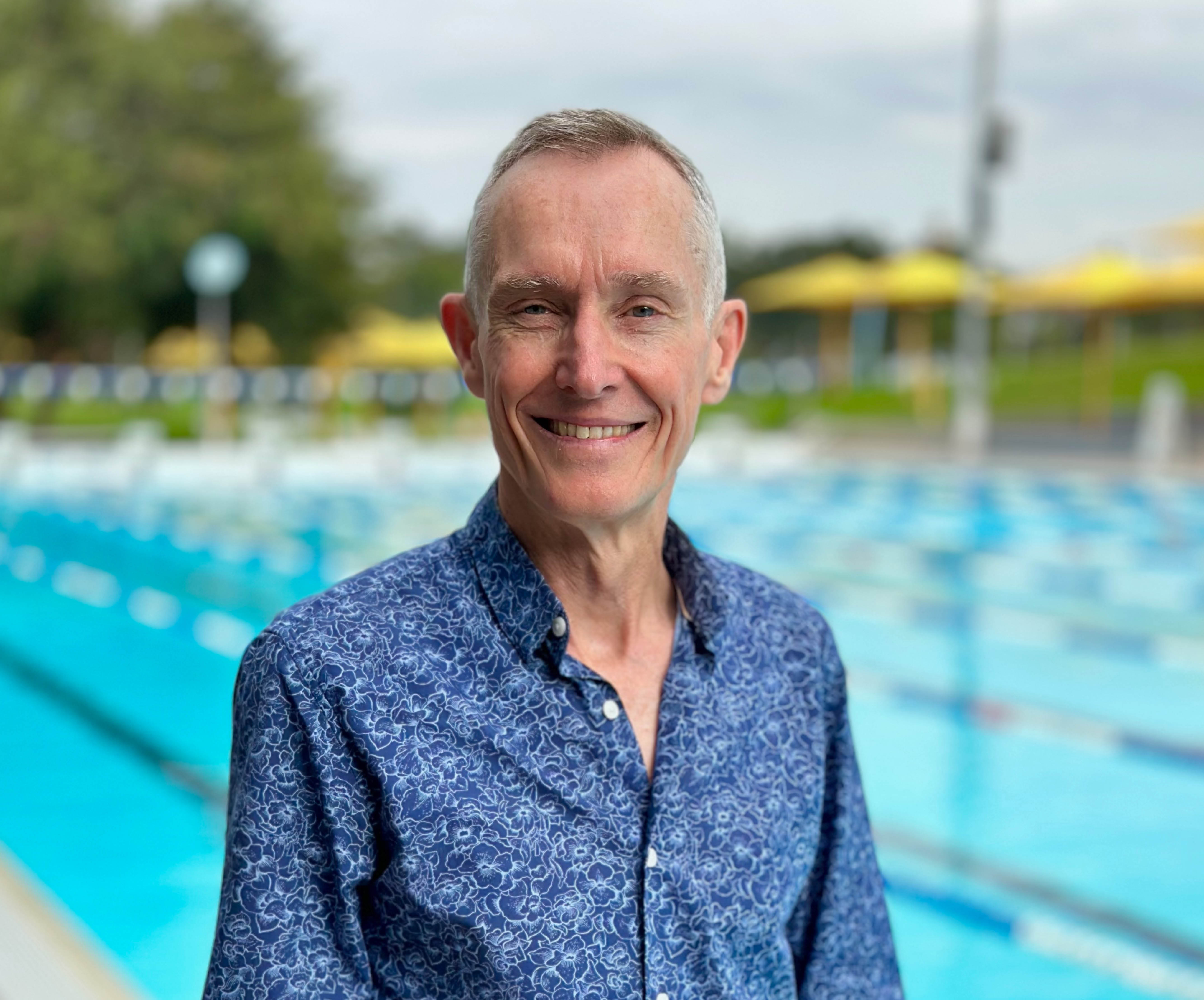 Chris Baker author photo with pool in background