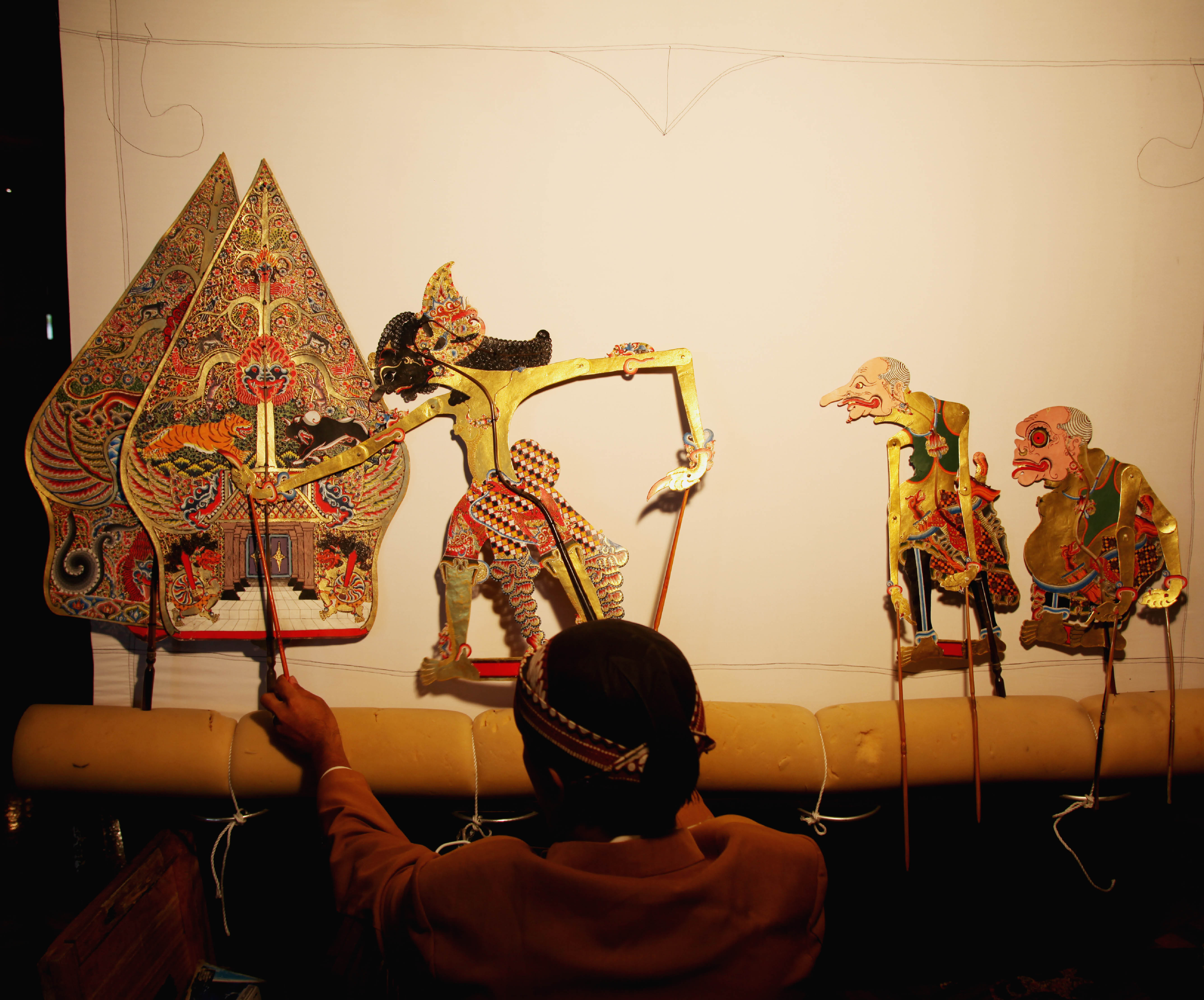 Indonesian Puppetry with puppeteer from the back 
