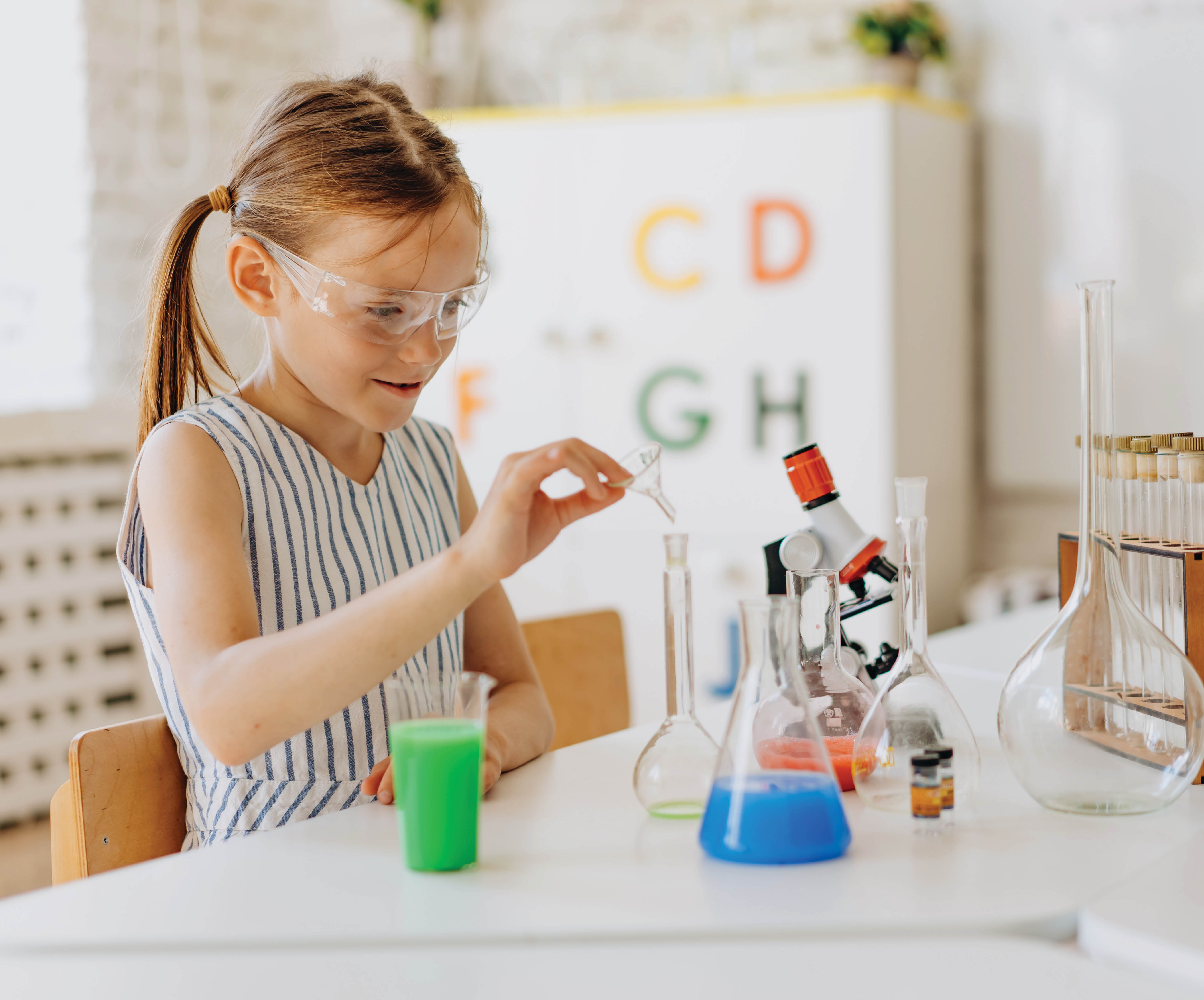 Blonde girl doing a science experiment