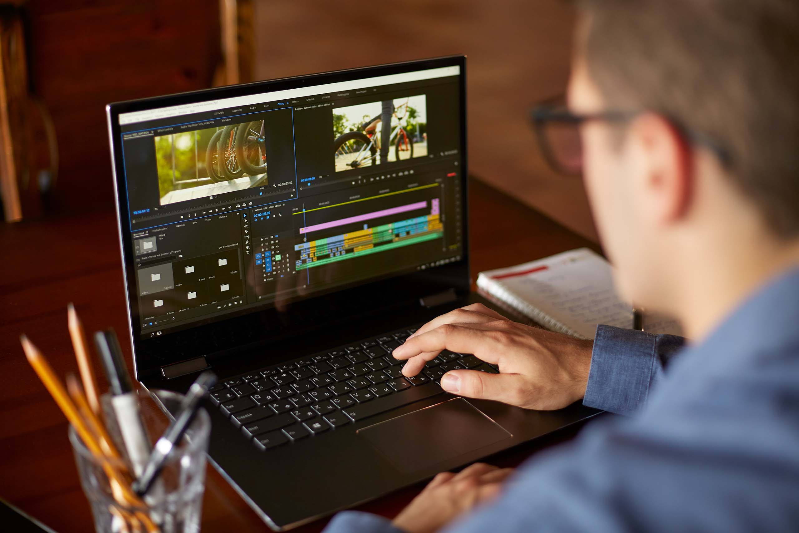 Man editing video on a laptop