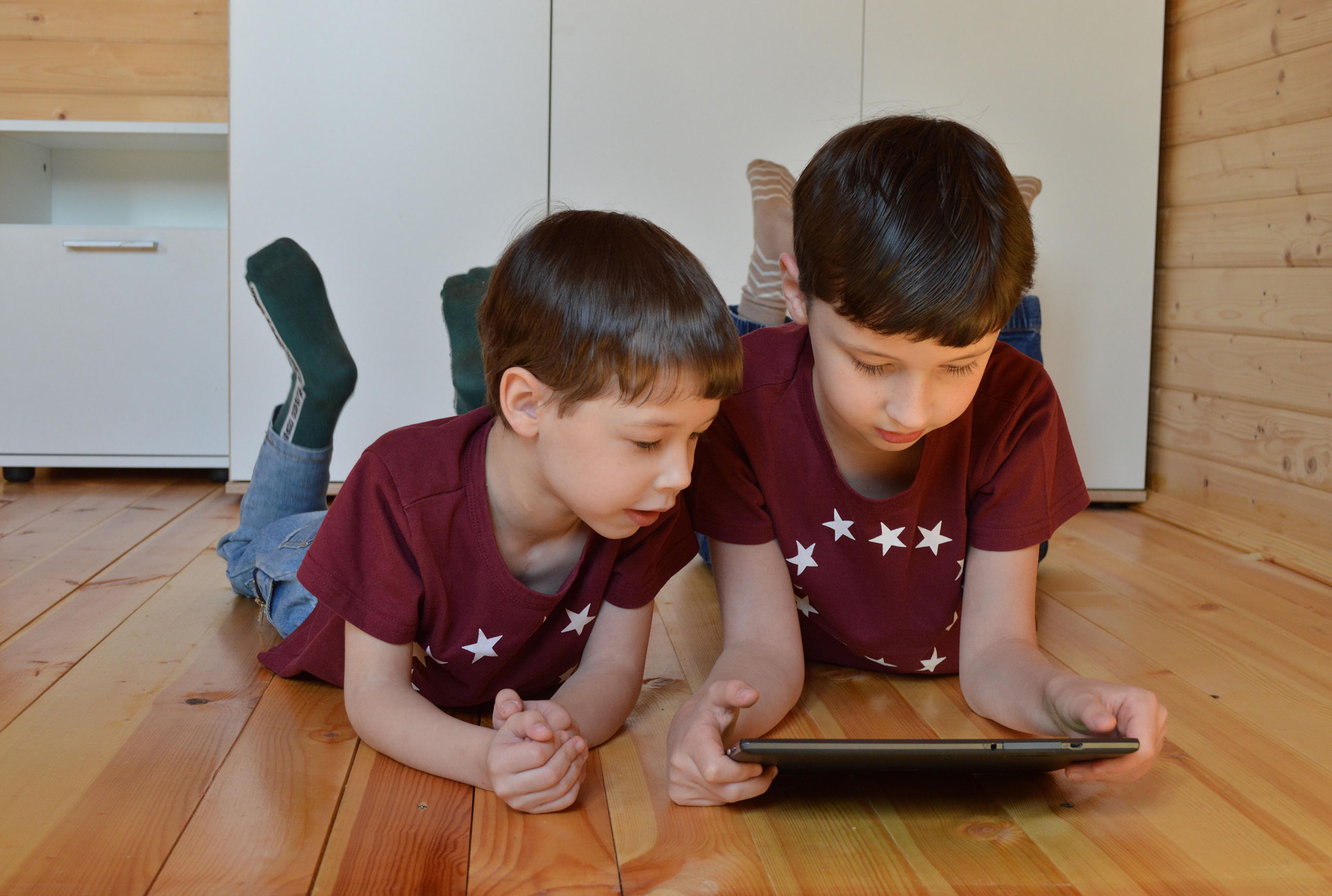 Two brothers sharing a tablet