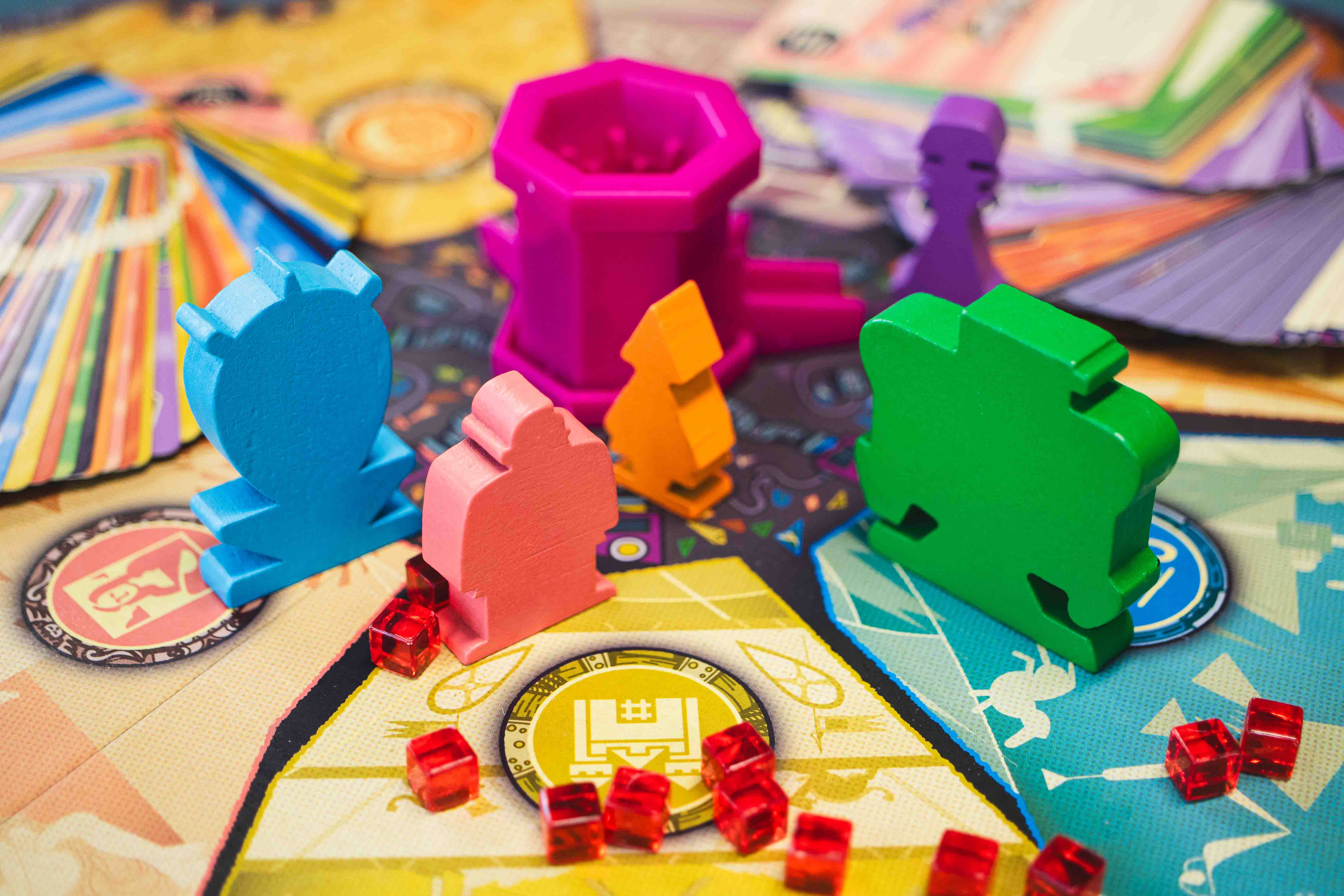 A close up shot of colourful board game piece on the game board