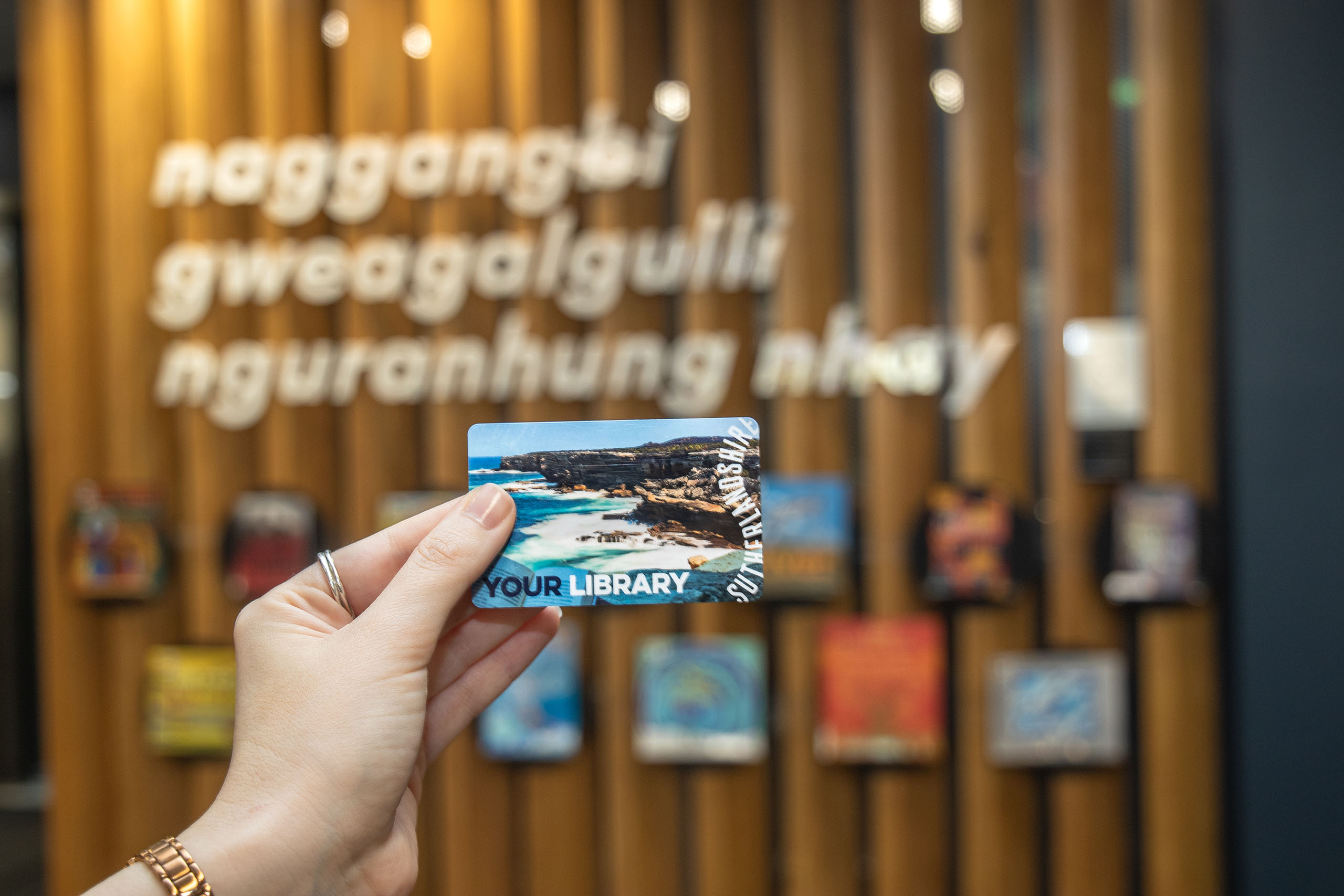 hand holding library card sutherland library