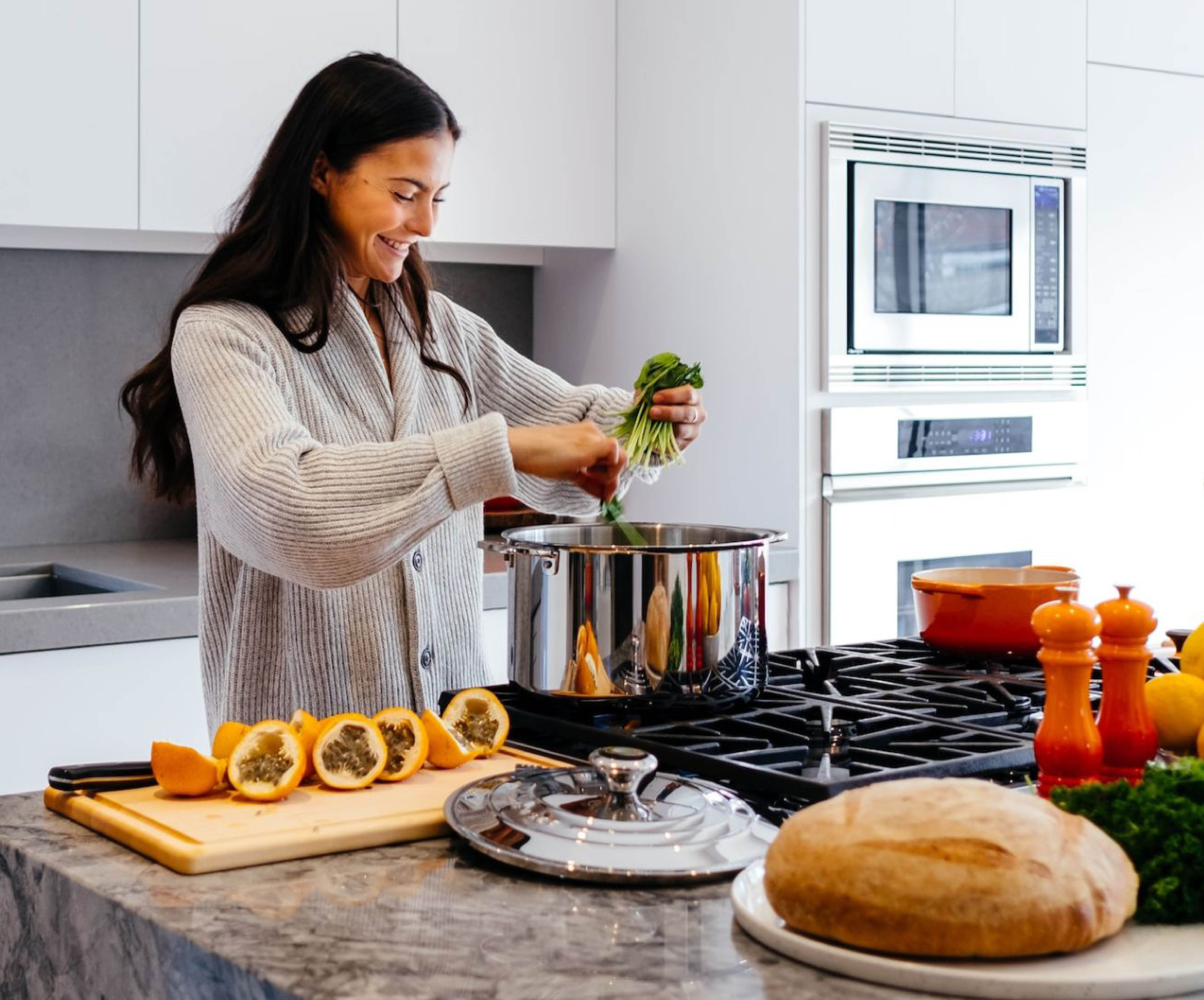 woman preparing meal at the kitchen bench