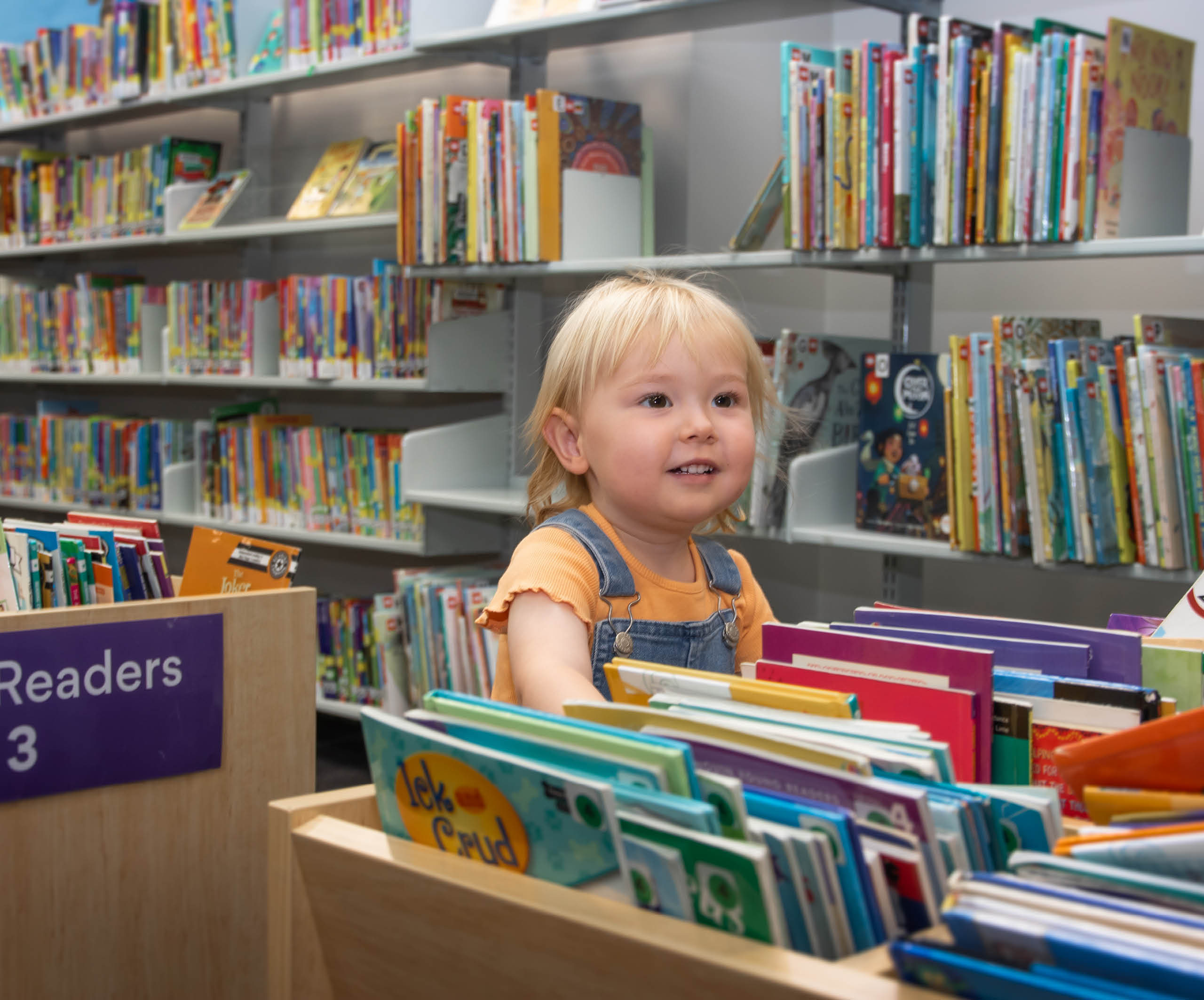 blonde toddler girl smiling easy readers sutherland library