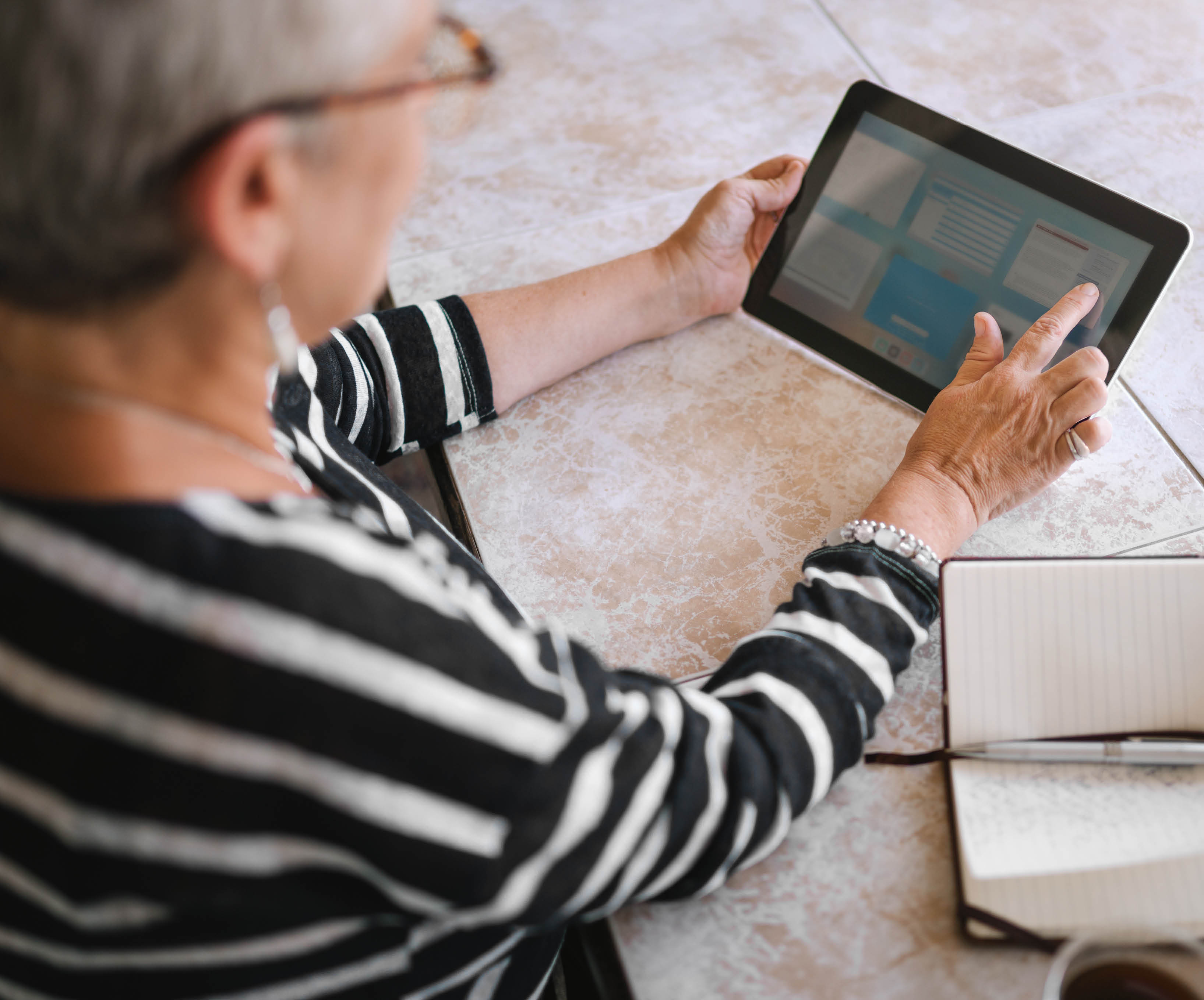 senior woman browsing applications on ipad