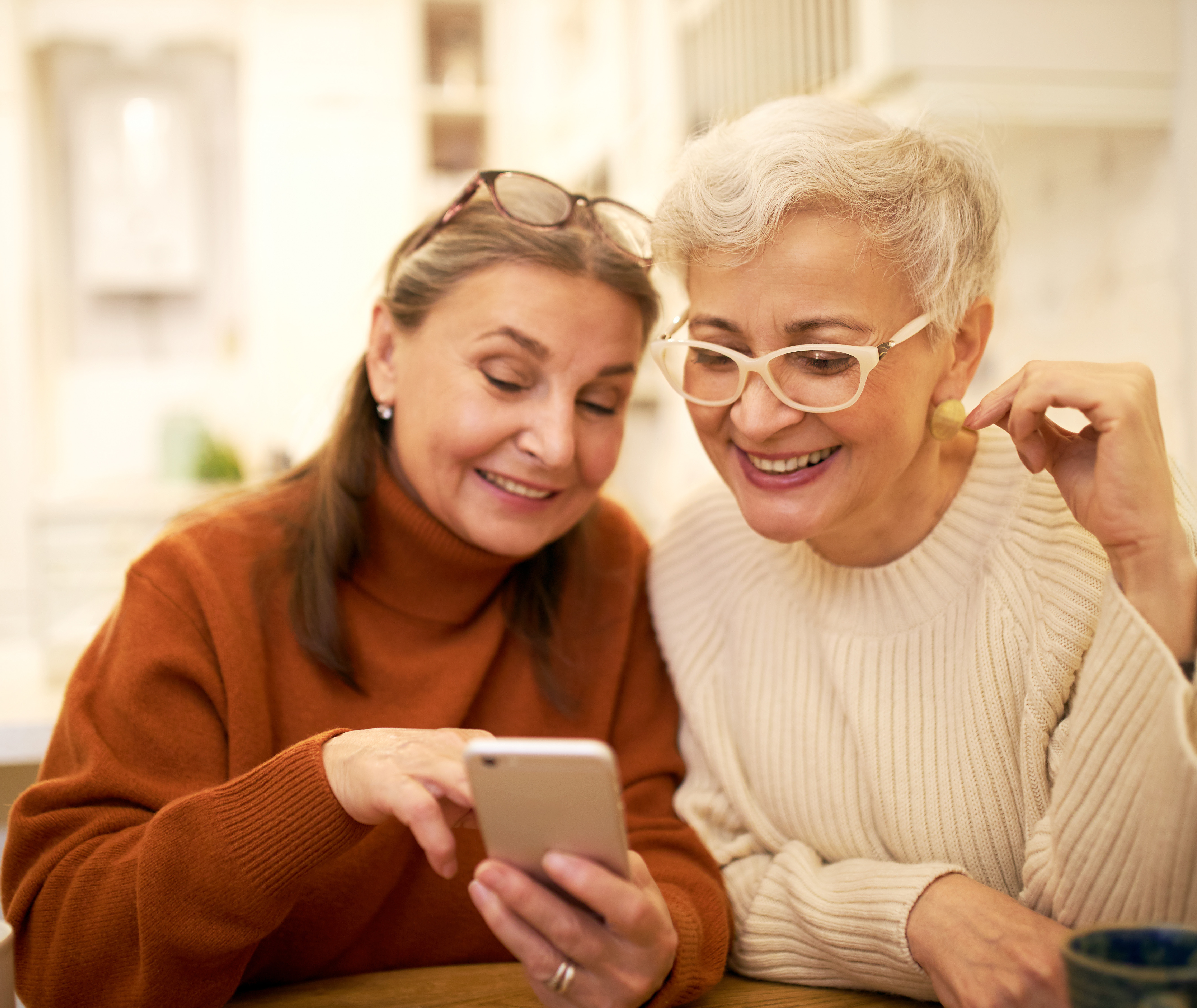 senior women smiling at iphone 