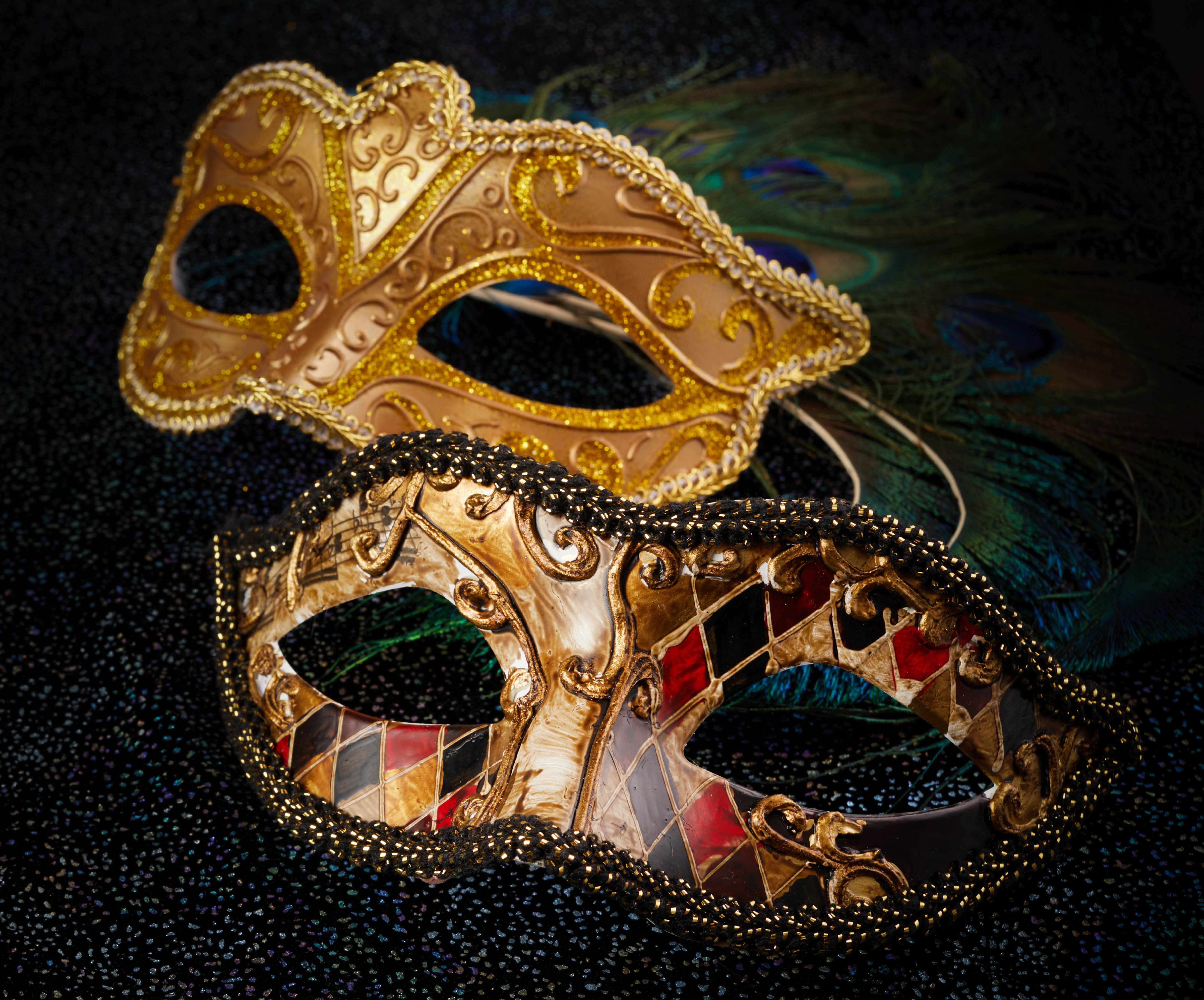 flat lay of two masks on black velvet