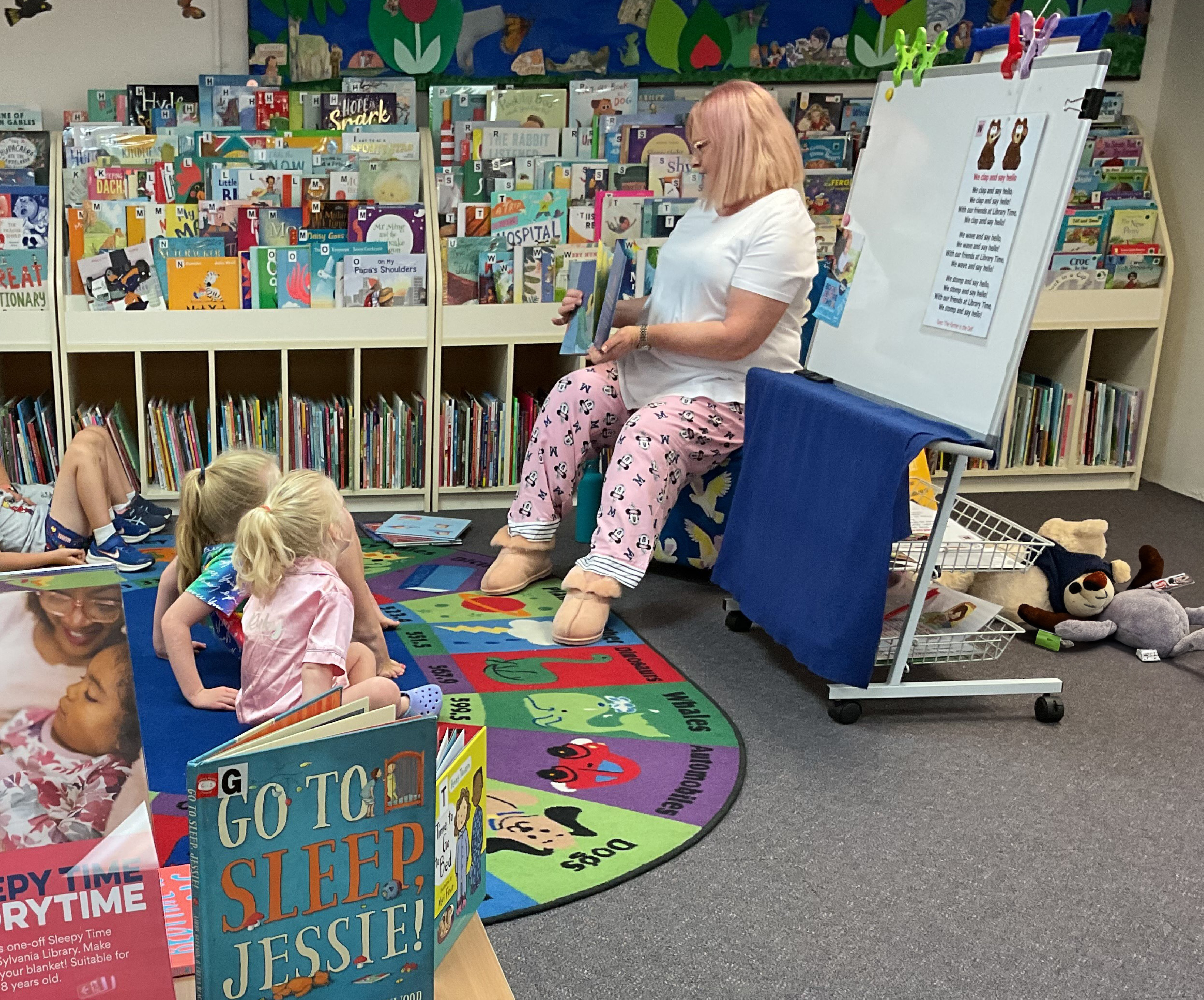 Librarian reading to children wearing pyjamas